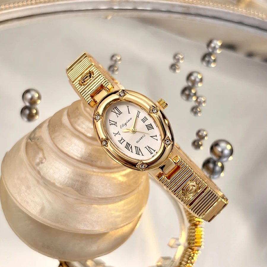 Classy Gold Watch for Women featuring Oval Dial, Star Motifs, and E-Charmed Band