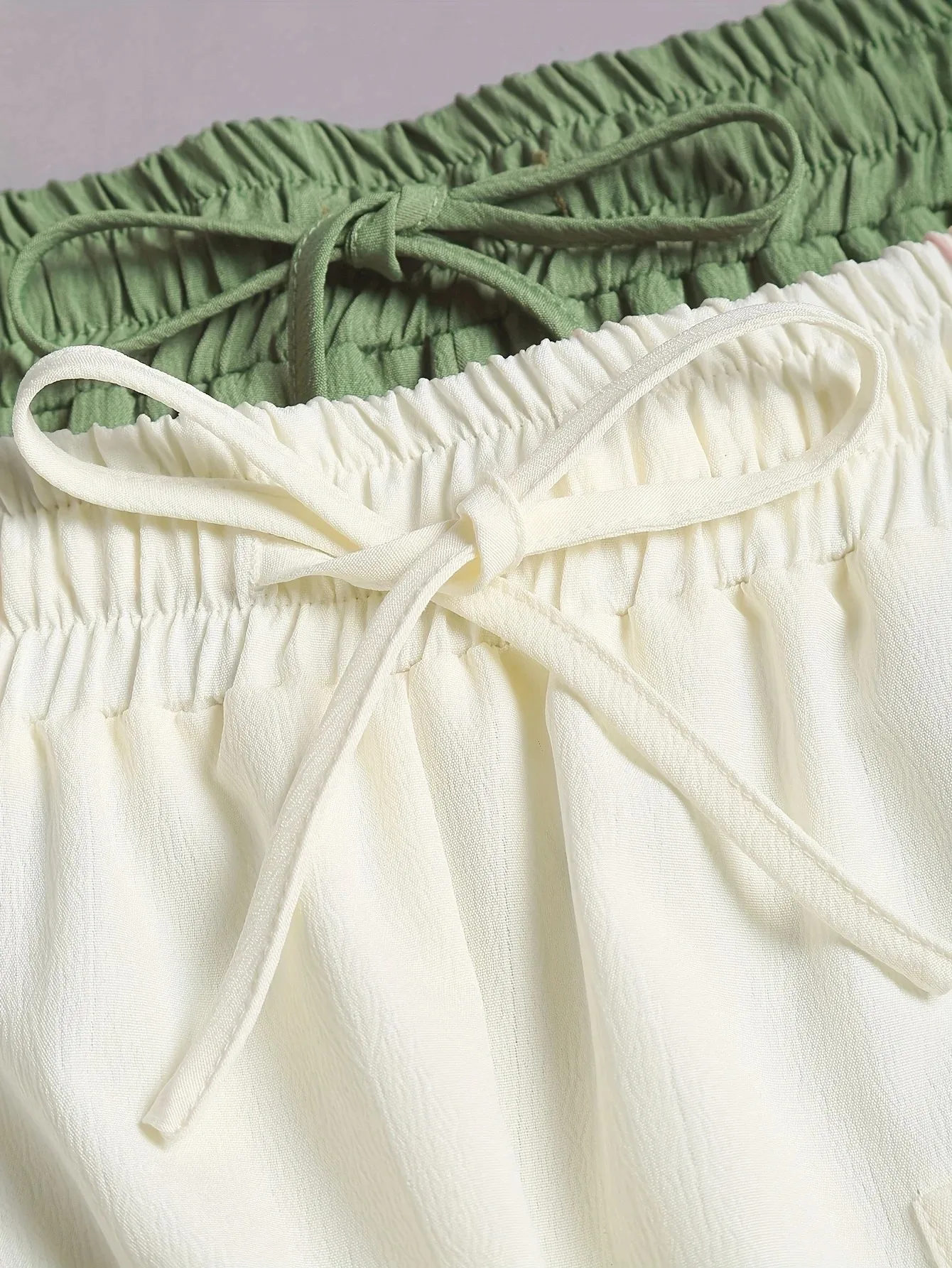 A 2-piece set of solid color casual drawstring shorts with pocket beach pants for women in 2026