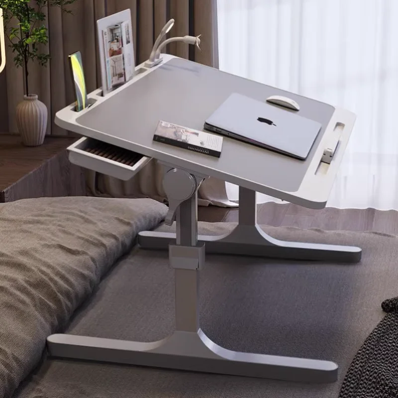 A small table on the bed that can be lifted, a computer table that can be folded, a study table that can be folded, a lazy perso