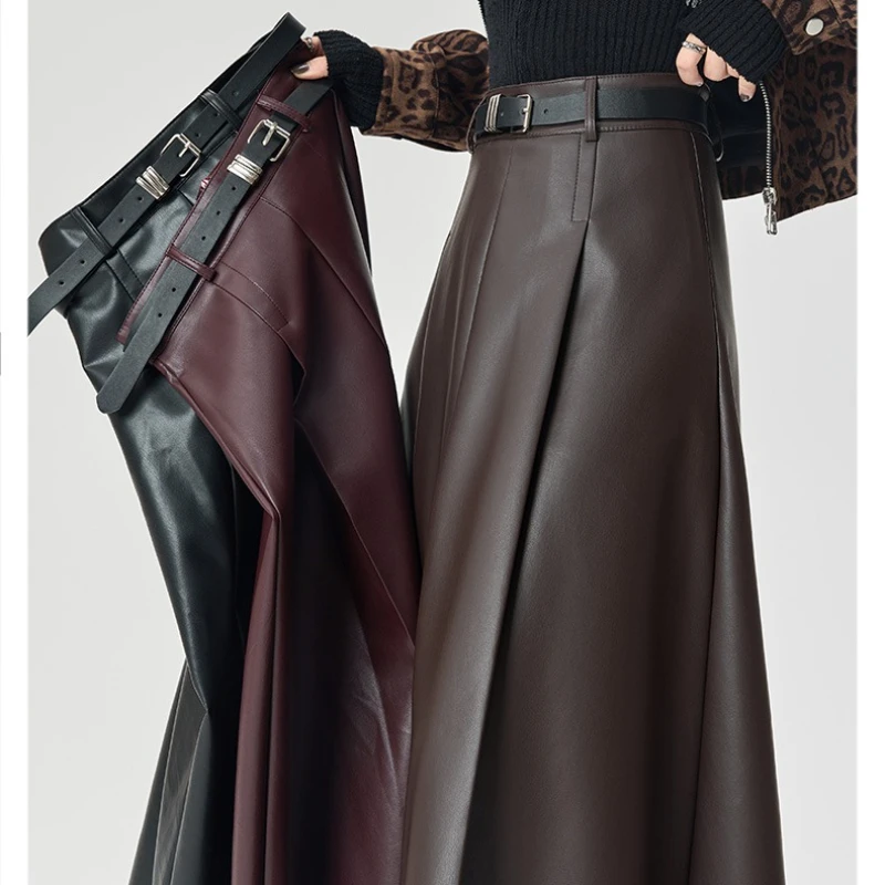 الخريف الشتاء عالية الخصر الأسود بولي Leather جلد المرأة مظلة تنورة طويلة مع مربوط 2025 جديد خمر مستقيم ألف خط التنانير الإناث