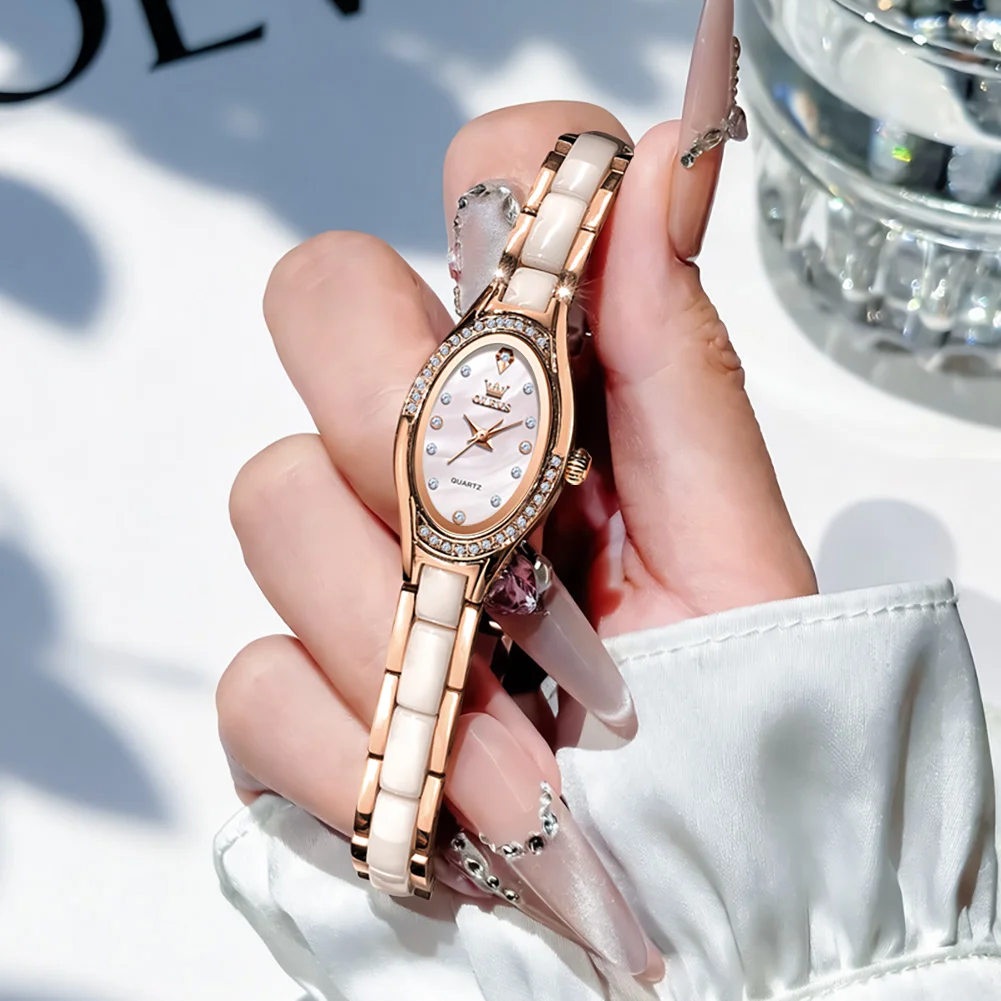 

Новые женские часы OLEVS, элегантные модные часы из розового золота с керамическим ремешком, овальным циферблатом, бриллиантовым безелем, кварцевые наручные часы 7131