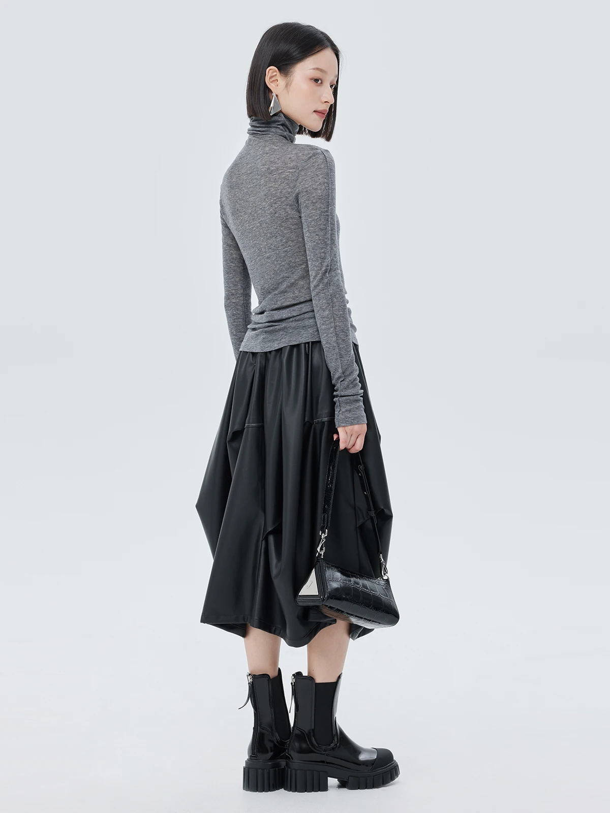 Nowa damska spódnica na jesień i zimę, czarna, asymetryczna, o średniej długości, elastyczna, z wysokim stanem, ze skóry ekologicznej (PU).