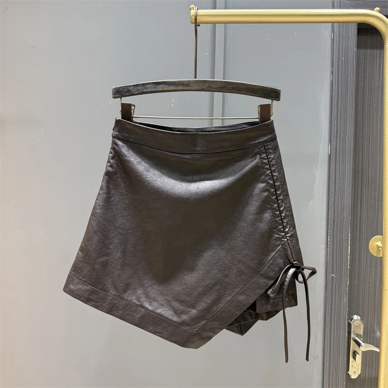 Irregular strap design spicy girl PU leather half skirt women's autumn winter new temperament slimming A-line short skirt