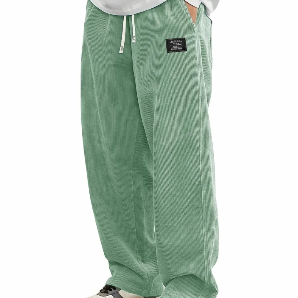 Novas calças compridas confortáveis de outono masculinas europeias, calças casuais de tecido de veludo com logotipo solto