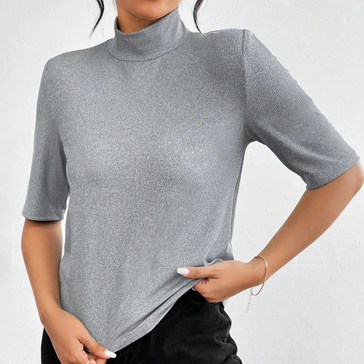 A grey high-neck, straight-shoulder, mid-sleeved T-shirt with a base layer and a three-quarter sleeved top inside