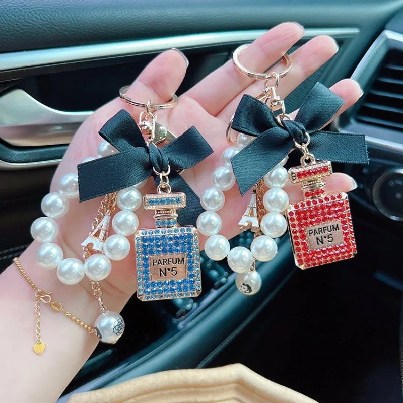 Alloy diamond inlaid bow shaped perfume bottle key chain creative pearl chain bag pendant exquisite key chain image 3