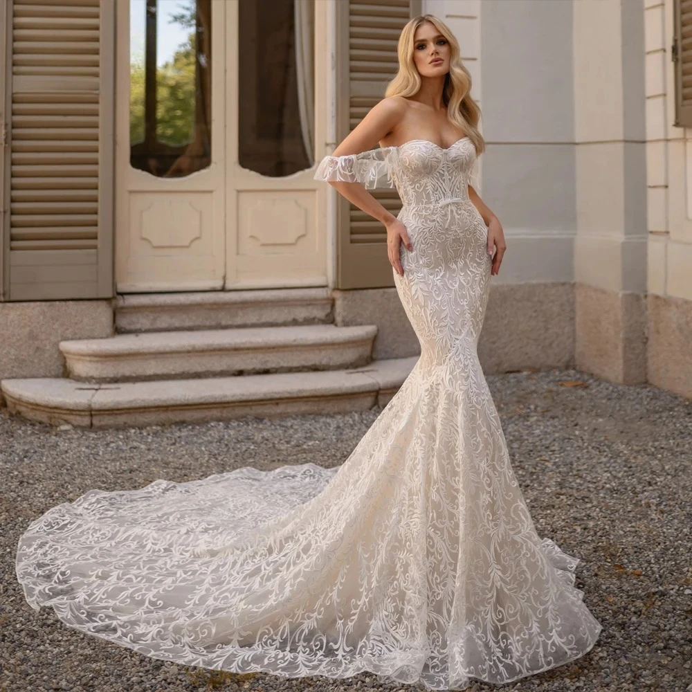Customized Off Shoulder Curved V Fitted Silhouette Gown Ruffled Cuffs Floral Motif Structured Corset Torso Wavy Flared Hem Dress