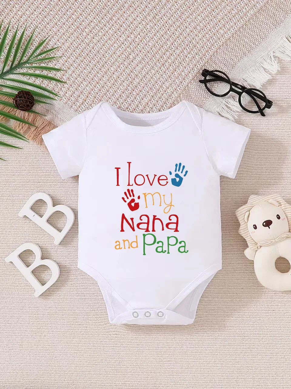 Playful letter-printed baby short-sleeve triangle bodysuit. Button closure for easy dressing