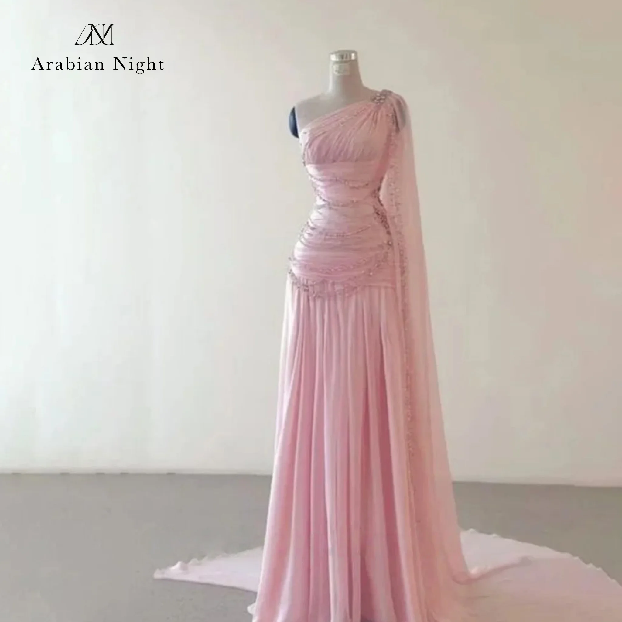 Pink floor-length formal gown featuring a pleated beaded one-shoulder bodice with a draped shoulder detail