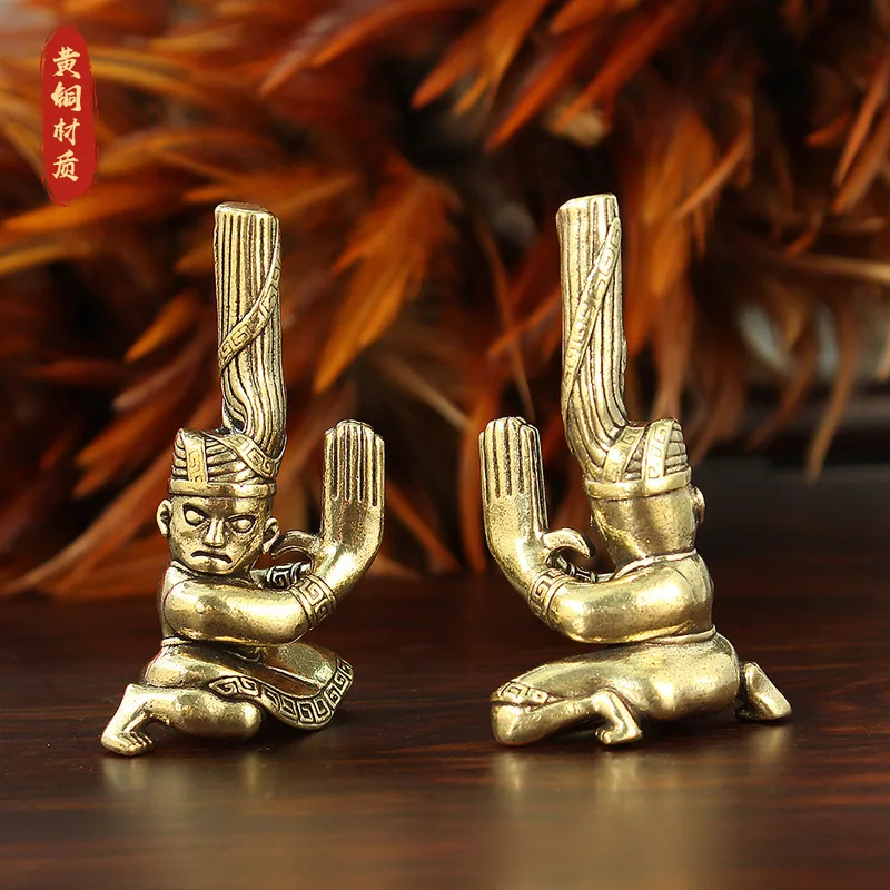 Brass figure statue, twisted head, kneeling posture, Guanghan Sanxingdui creative scenic area, prominent eye