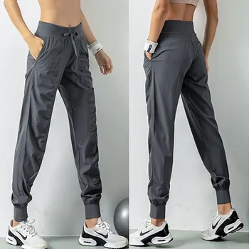 Pantalones deportivos de secado rápido para mujer con dos bolsillos laterales