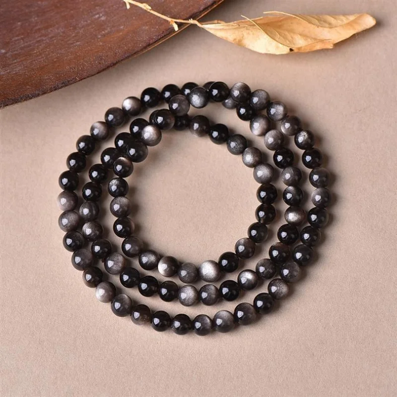 

Натуральный двусторонний браслет с эффектными круглыми бусинами из серебристого обсидиана, модный и универсальный.