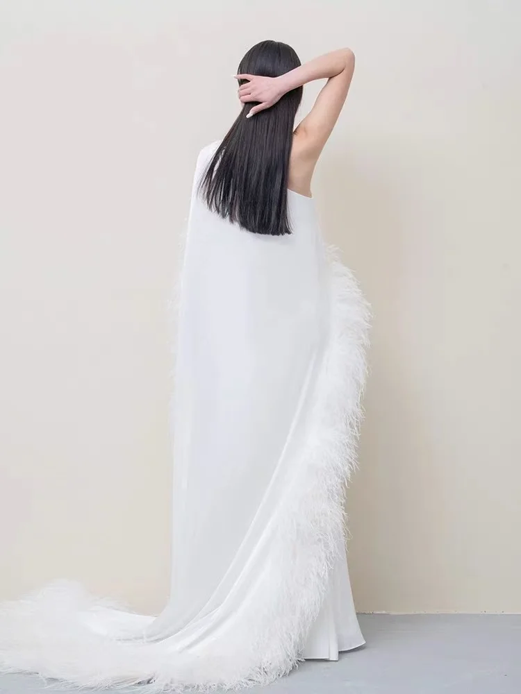 White elegant lady high-end bridal dressing gown evening dress one-shoulder tail dress