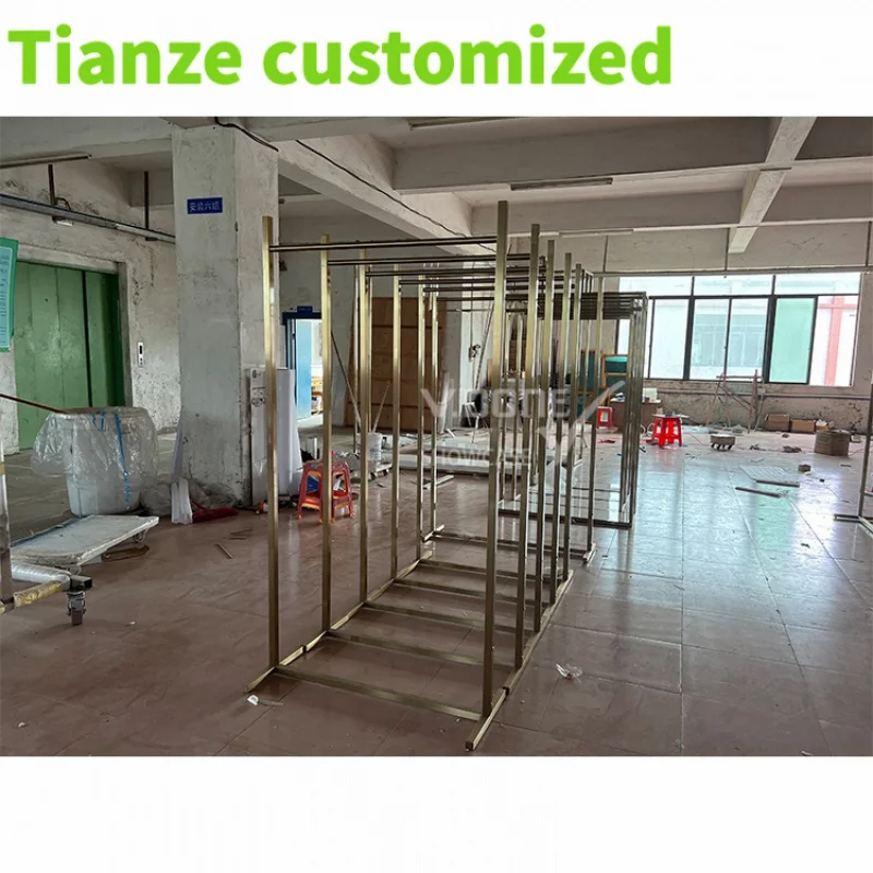 Customized-Modern Famous Customized Hanging Garment Display Rack Golden Clothing Display Stand Clothes Store Interior