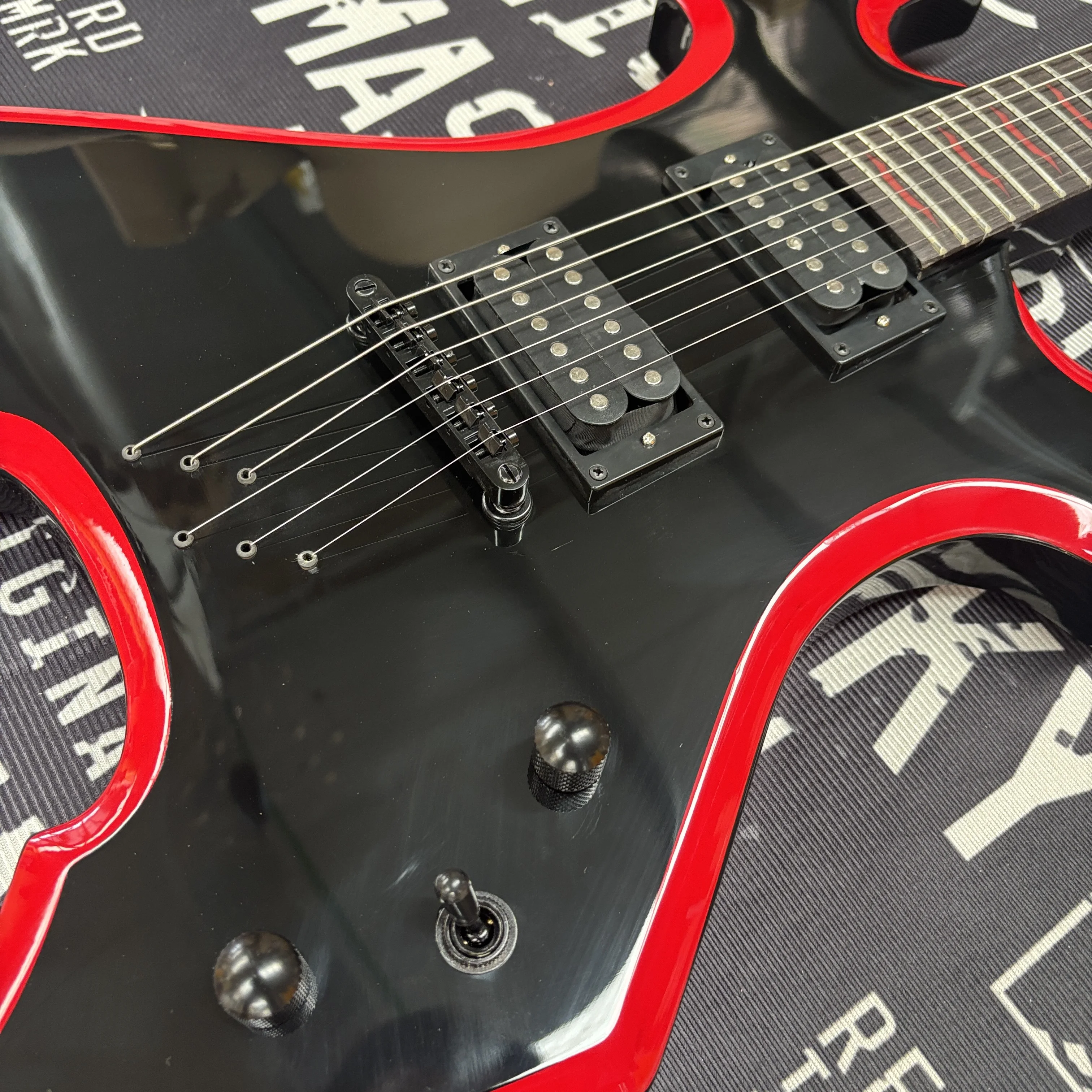 6-string electric guitar with black and red color contrast design,dual knobs for tone control guitars—stylish beginner guitarra