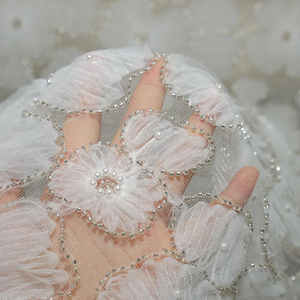 The new irregular three-dimensional floral beaded and sequined lace fabric is suitable for wedding parties