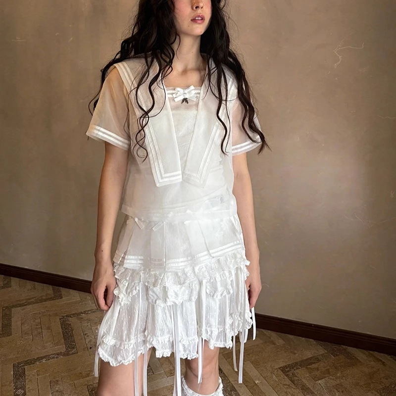 2025 الربيع الصيف الخريف الأبيض القوس لطيف المرأة مطوي تنورة قصيرة التصميم الأصلي الحلو شاش شفاف ضرطة الستار السيدات