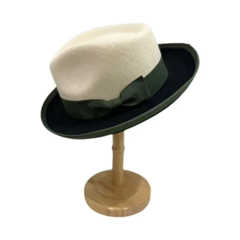 A white and black patchwork top hat with knot decoration felt