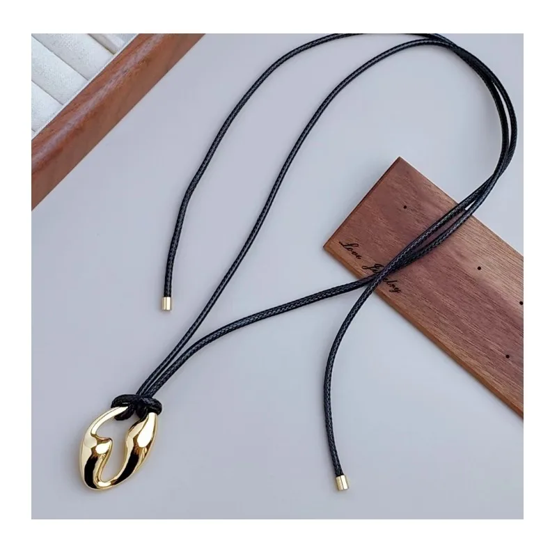 

Autumn and Winter Long Character Hollow Pendant Necklace Black Leather Rope Sweater Chain Design Sense Niche High Sense Item Dec