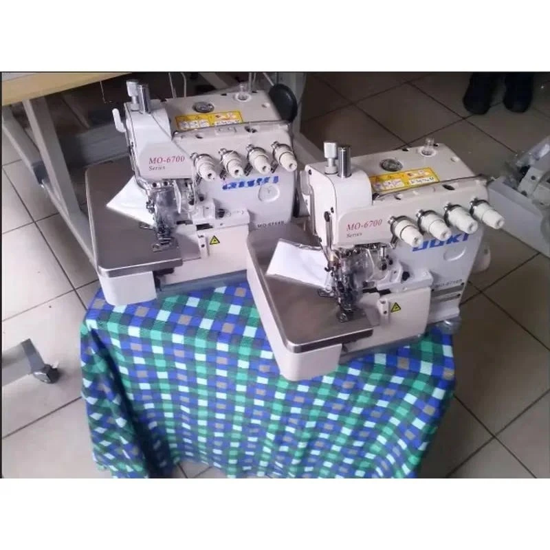 Used High Speed Jukis 6714S Four 4 Thread Industrial Overlock Sewing Machine with Motor 5500 Sti/min 5-10mm Thickness