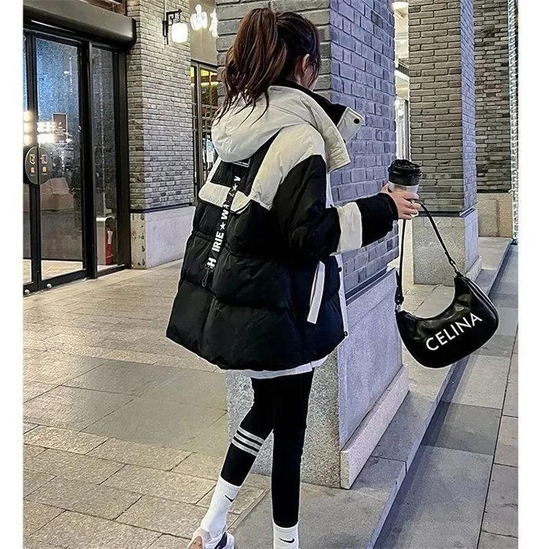 Chaqueta de algodón Parker negra de longitud media para mujer, nueva versión coreana 2026, abrigo con capucha de algodón suelto y empalmado, cálido para invierno.