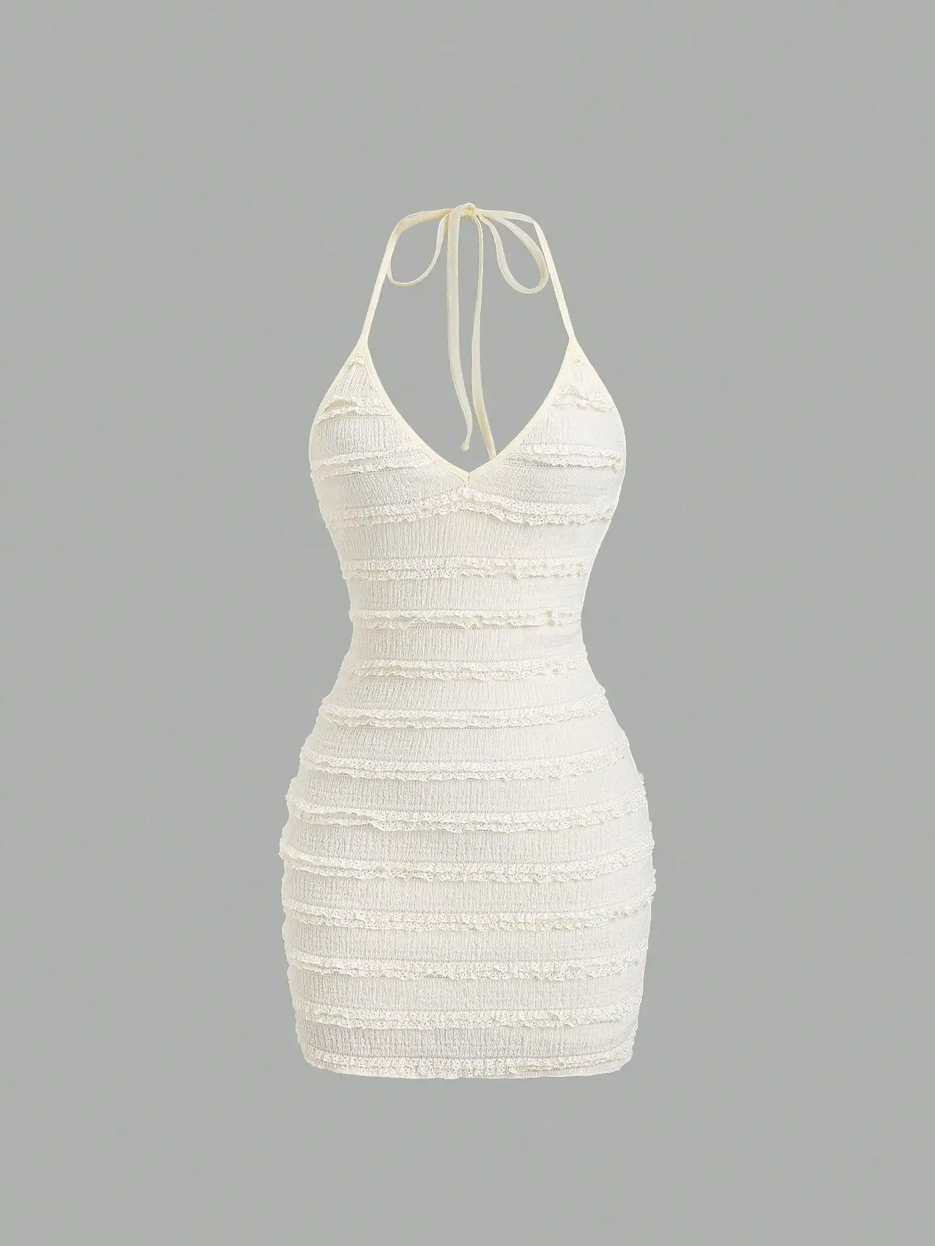 

Кремовое вязаное мини-платье с воротником-халтер, рюшами и завязками на спине