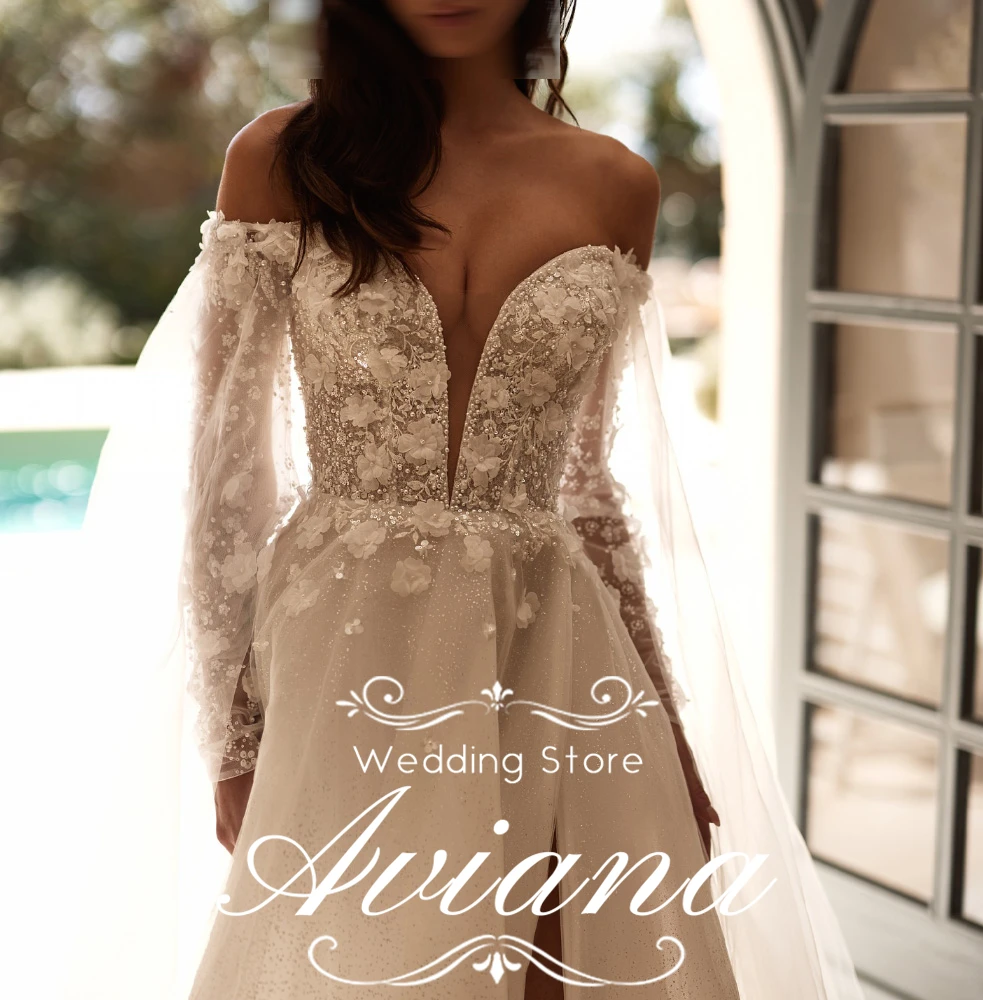 فستان زفاف Aviana مخصص قبالة الكتف وأكمام طويلة ورقبة على شكل V عميقة ومطرز بالخرز من الدانتيل مع فتحة عالية وقطار طويل