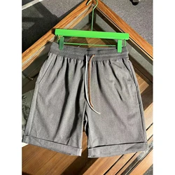 Pantalones cortos de algodón y lino para hombre, Shorts transpirables, informales, a la moda, de cinco puntos, para gimnasio, novedad de verano 2024