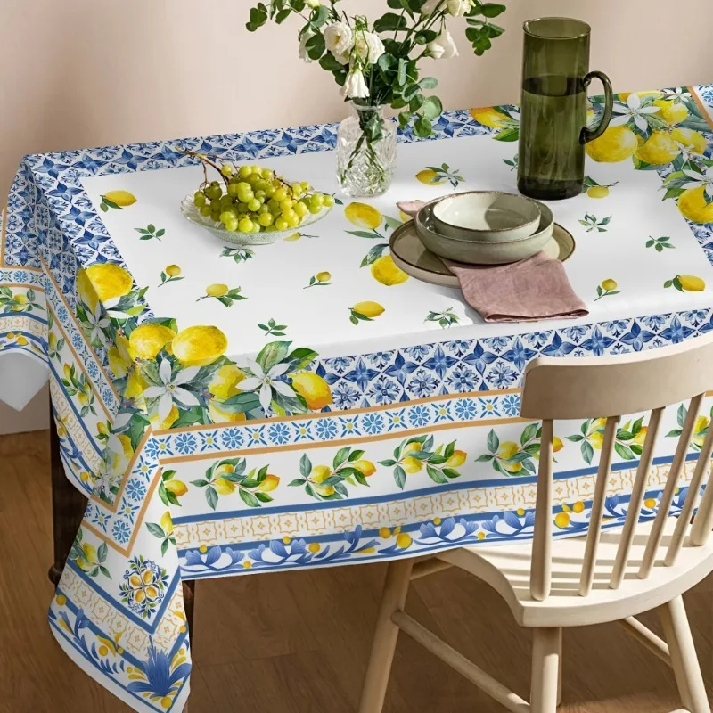 A tablecloth with yellow lemons and blue patterns, in a traditional Mediterranean style.