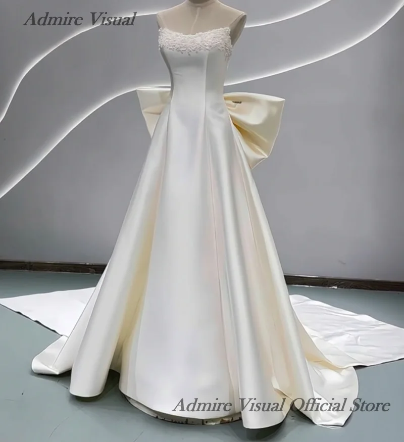 분리 가능한 큰 리본이 달린 A라인 새틴 민소매 비주얼 웨딩드레스를 감상하세요. 맞춤 제작 가능한 신부 가운