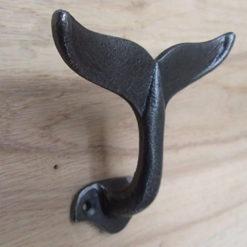 Wall hooks, decorative hooks in the shape of cast iron whale tails, used to hang coats, clothes, hats or to display costumes in