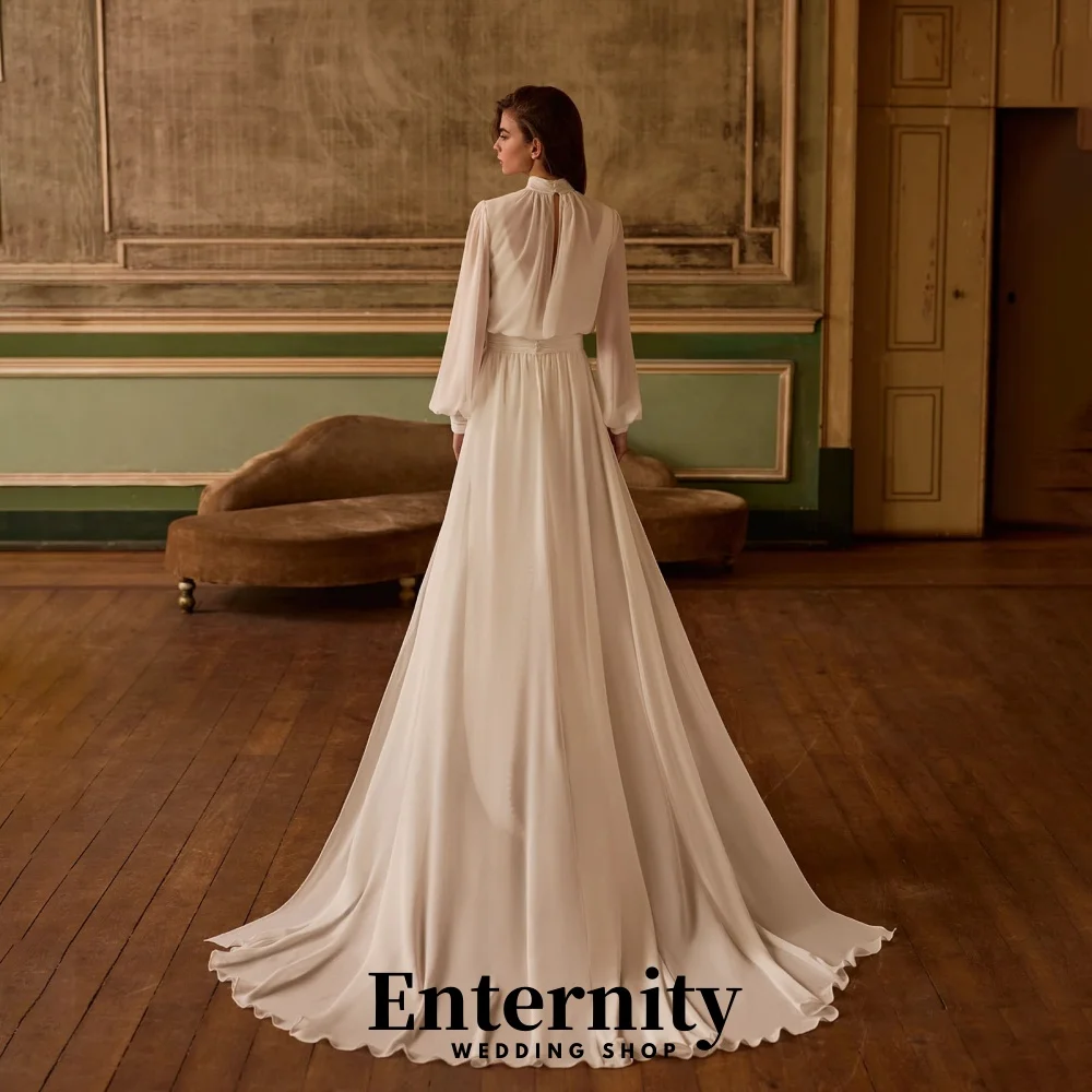 カスタマイズされたバックレスウェディングドレスエレガントなハイネック長袖女性のための魅力的なフリルブライダルガウン Vestidos De Novia