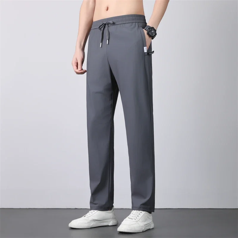 رقيقة تنفس السراويل الرجال 7XL الحرير الجليد الصيف التجفيف السريع فضفاض مستقيم مرونة عالية السراويل الرياضية الركض سراويل تقليدية