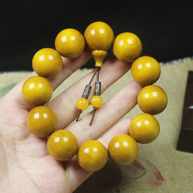 

Colored golden , smooth-grained nanmu dark wood bracelet in yellow and green colors