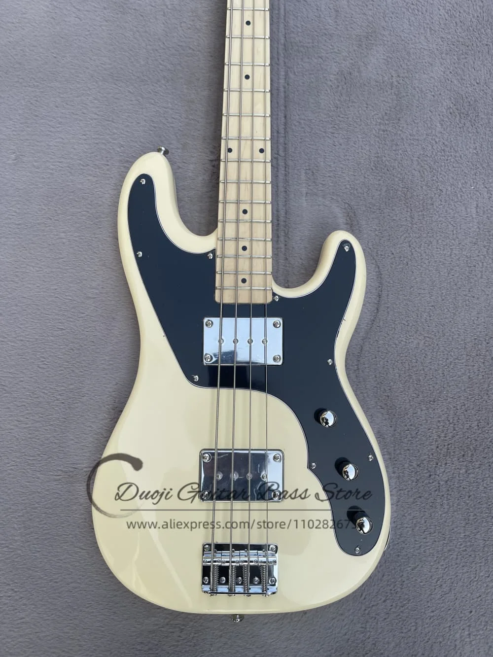 4 string cream color guitar, fixed bass bridge, solid wood body, maple neck, large soapbar pickup, black plate