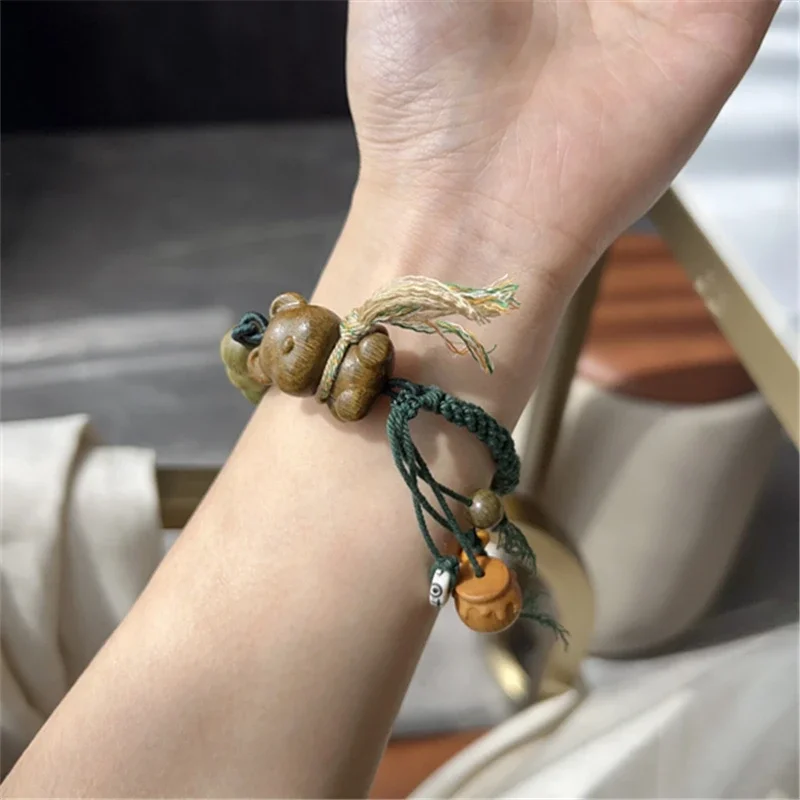 Green sandalwood bib teddy bear bracelet paired with green sandalwood round bead roots and Adai sandalwood honey jar