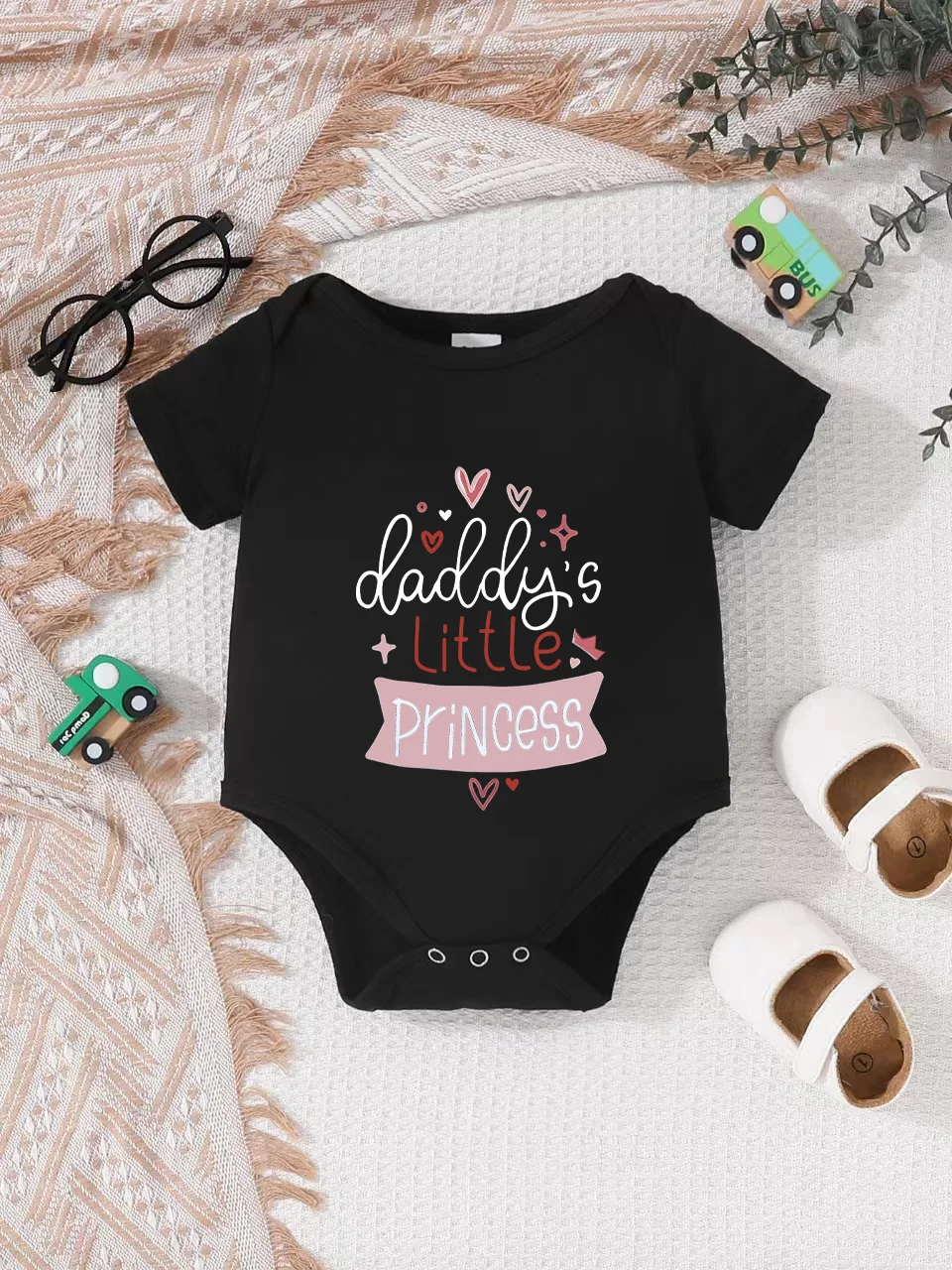 Playful letter-printed baby short-sleeve triangle bodysuit. Button closure for easy dressing