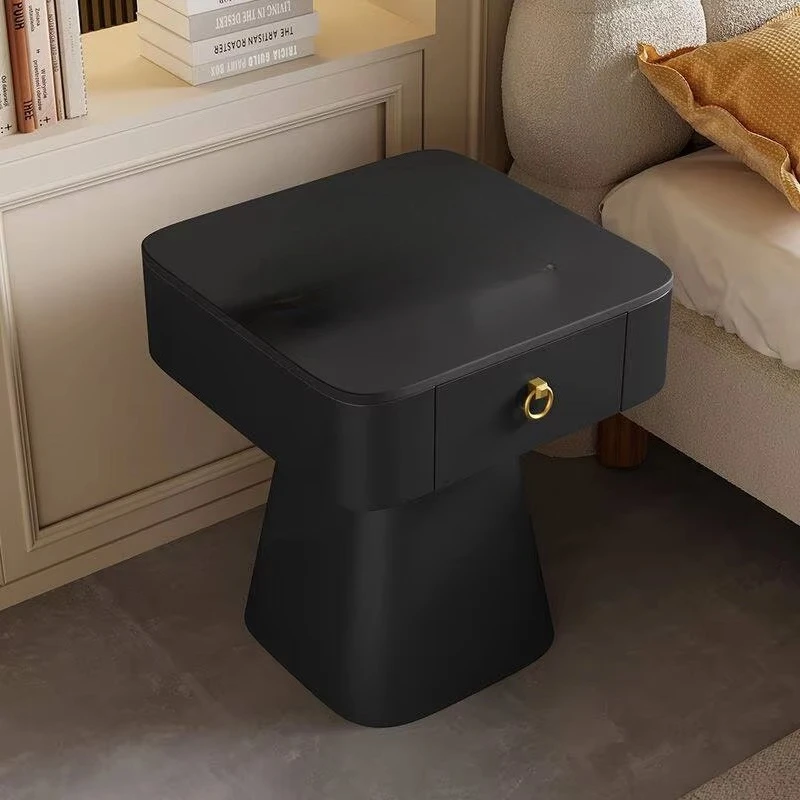The white coffee table features a sintered stone countertop and storage drawers, with foldable solid wood legs