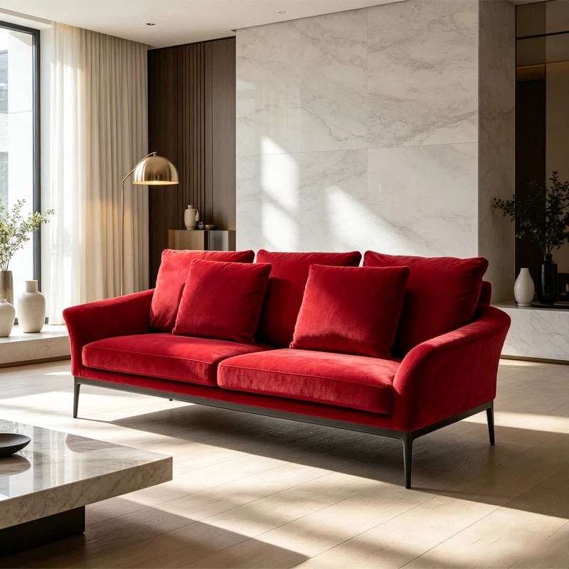 Bright red velvet sofa with aluminum base and armrests, elegant and understated three-seat modern padded sofa, luxurious