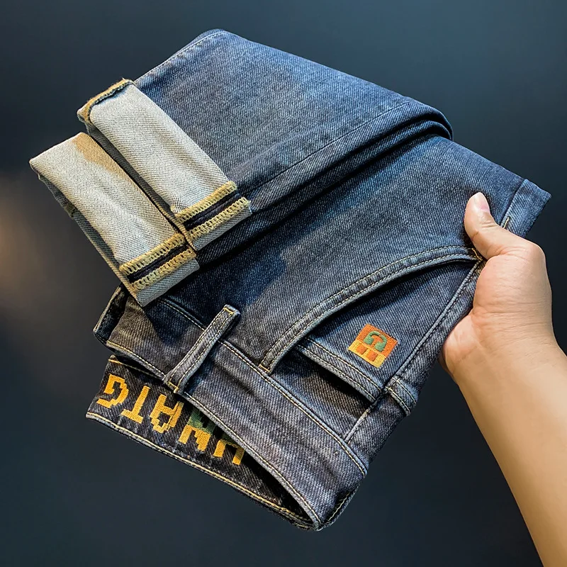 Celana jeans bordir kaki elastis pria, celana panjang tebal desain kantung miring modis musim gugur 2024