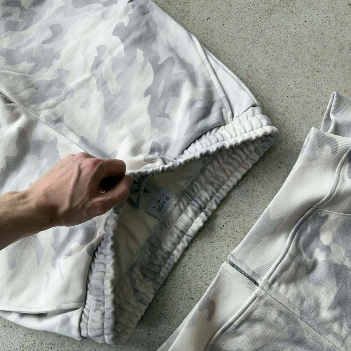 2025 hombres y mujeres high street hip-hop rap street Nueva cuerda elástica cremallera sudadera pantalones color sólido pantalones casuales