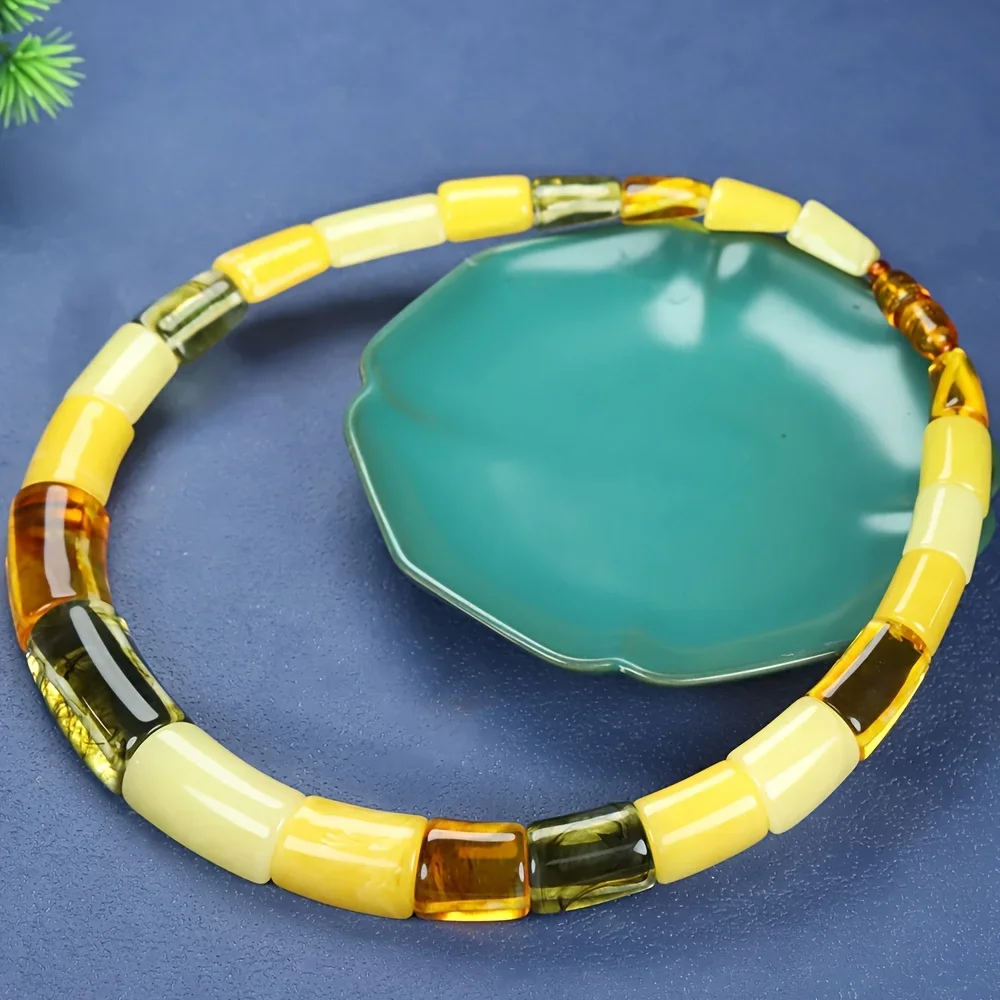 smoked amber, floating beeswax, discoloration when exposed to purple light, necklace