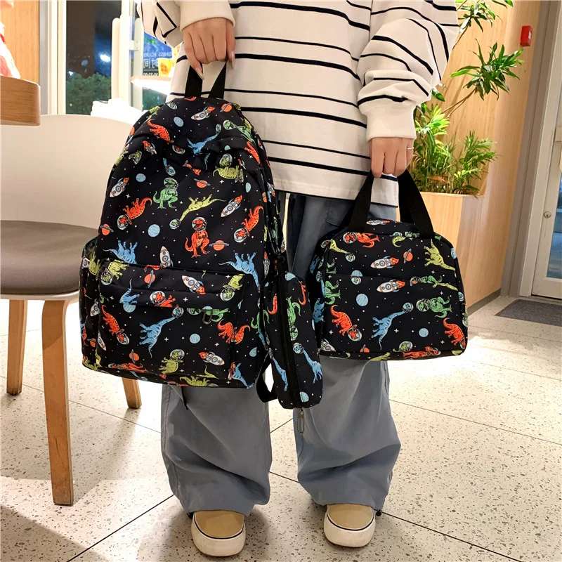 School season new middle school and college students schoolbag three-piece cartoon dinosaur backpack female graffiti portable pe