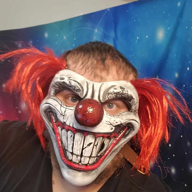 Scary clown Halloween mask with red hair, large teeth and horror face design