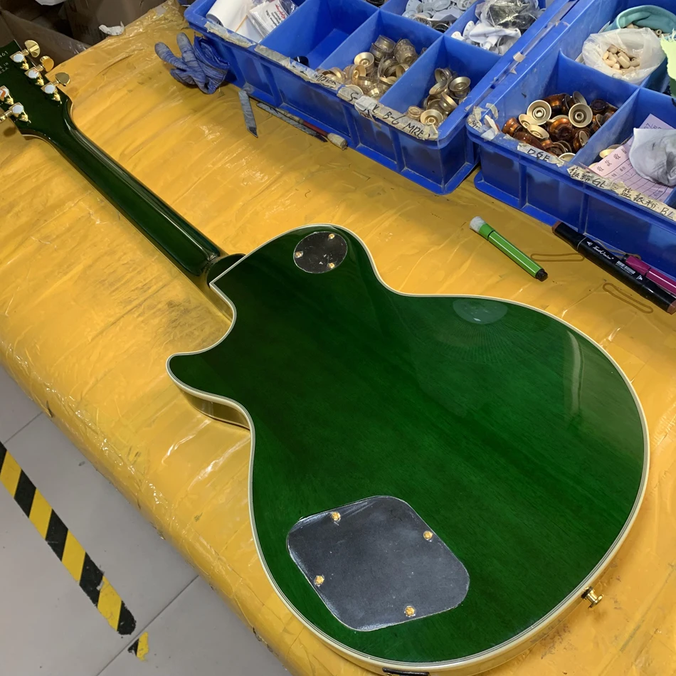 Electric guitar with green maple top, gold hardware, rosewood fingerboard