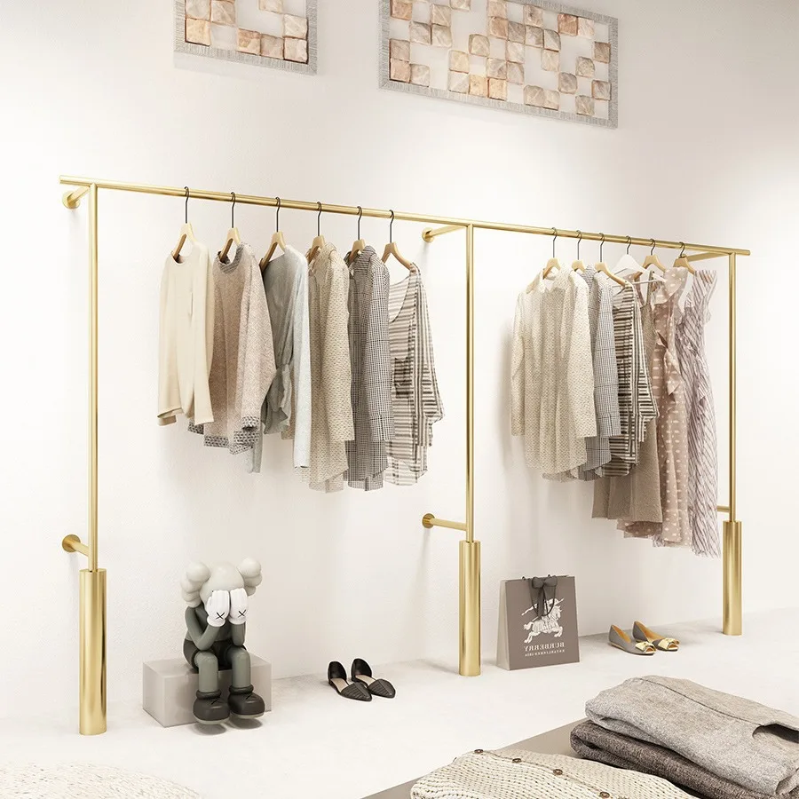 High-end clothing store display shelves, wall-mounted clothes poles, golden women's clothing store display shelves