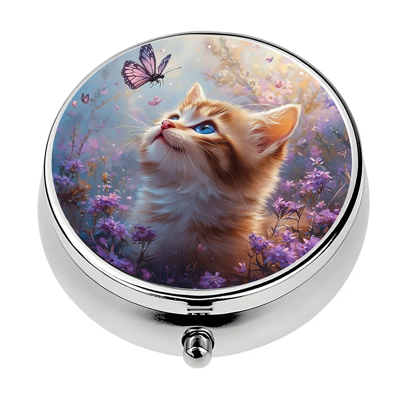 A small pill box, divided into three compartments, featuring a butterfly and kitten theme design. This metal pill box is a unique travel gift.