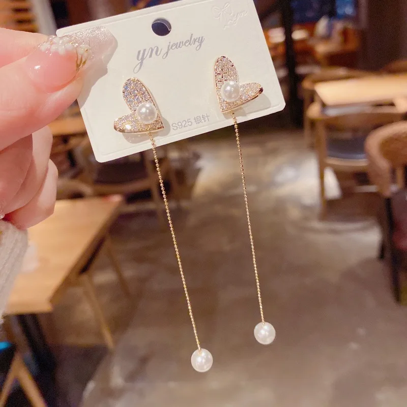 Stylish heart shaped pull out pearl tassel earrings for women popular online light luxury high end feel versatile face slimming