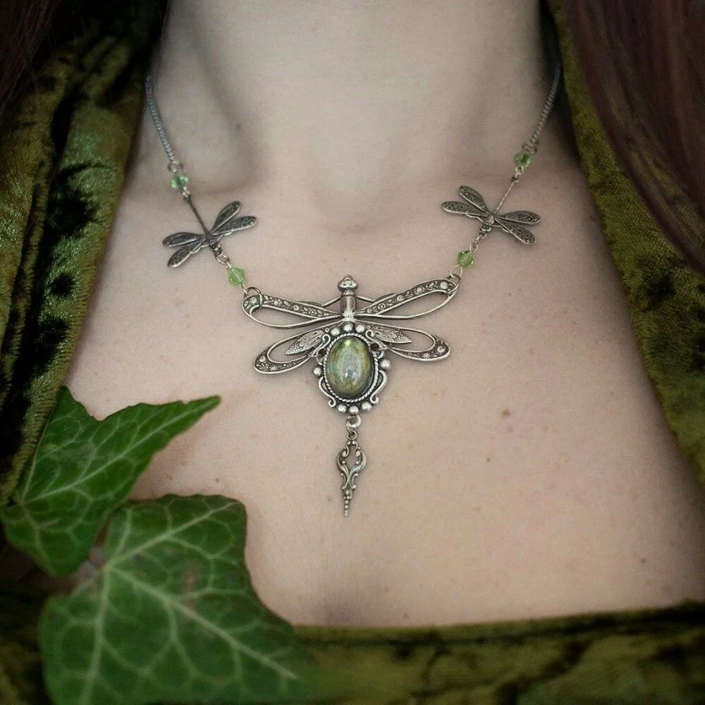 A necklace featuring ethnic-style small dragonflies arranged in a row, paired with an artificial gemstone pendant for the lady.