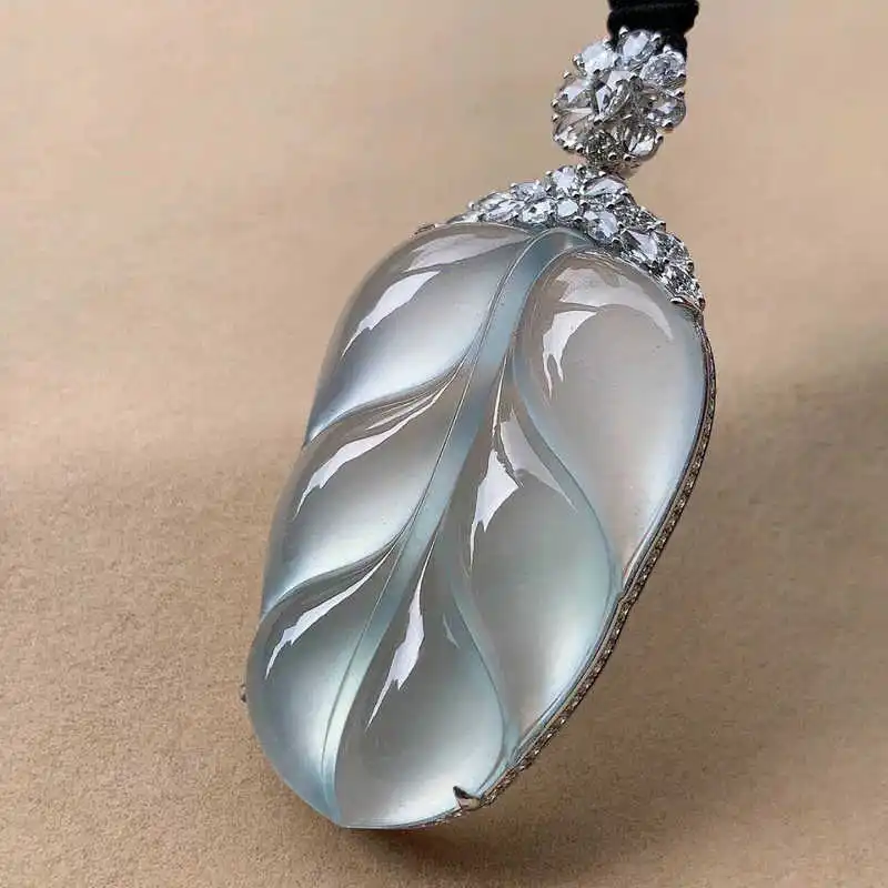 Natural ice pendant from Myanmar's old mines, inlaid with 1k gold, featuring a golden branch and jade leaf design